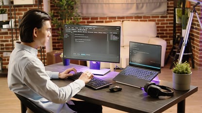 A man seated at a desk doing work