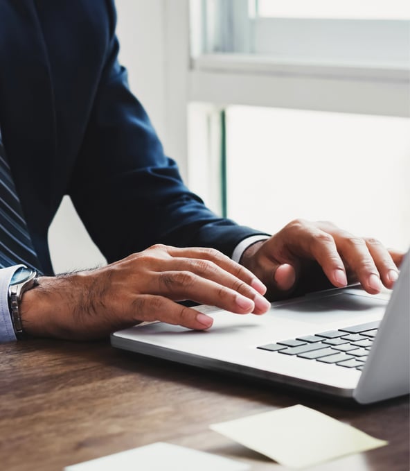 A person typing on a laptop