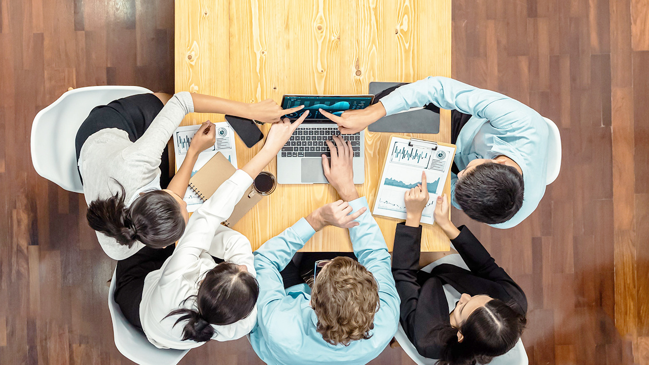 A team collaborating on a task around a table