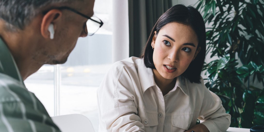 Close up of a lady speaking to her colleague