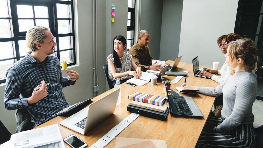 Image of a business professional in discussion about digital solutions with other workers