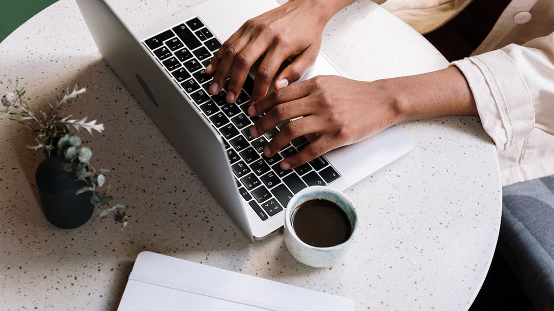 Image of person typing on their laptop